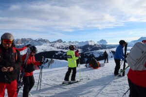 A bunch of skiers learning how to ski in a group lesson.
